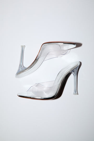 A pair of Alexa Glass high-heeled mule sandals with slim stiletto heels, displayed on a clean white background.