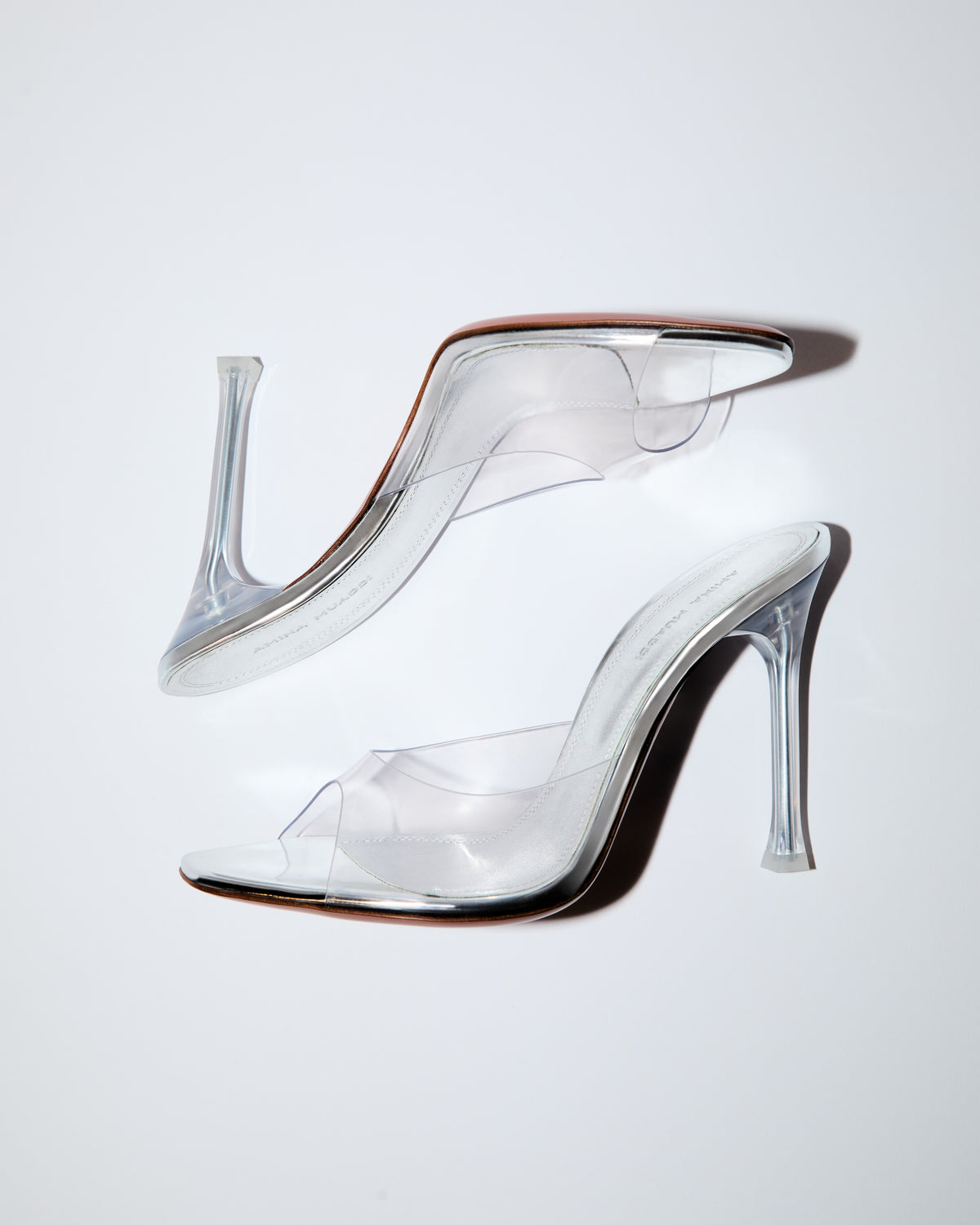 Amina Muaddi Alexa Glass PVC slipper with sculpted stiletto heel, worn at the Victoria’s Secret Fashion Show 2026